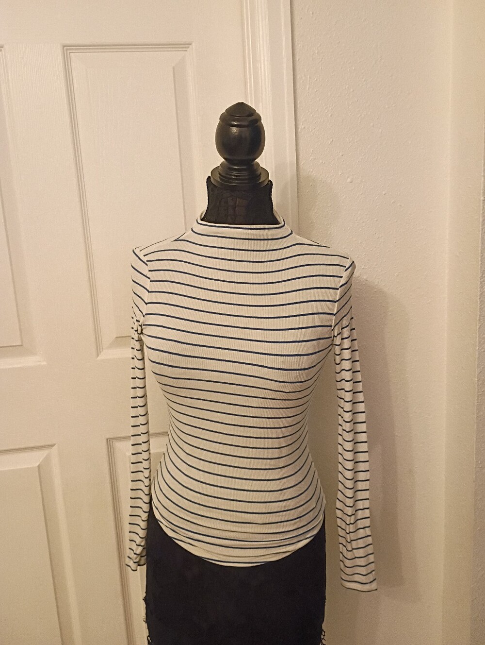 Ivory ribbed long-sleeve top featuring thin blue horizontal stripes and a mock